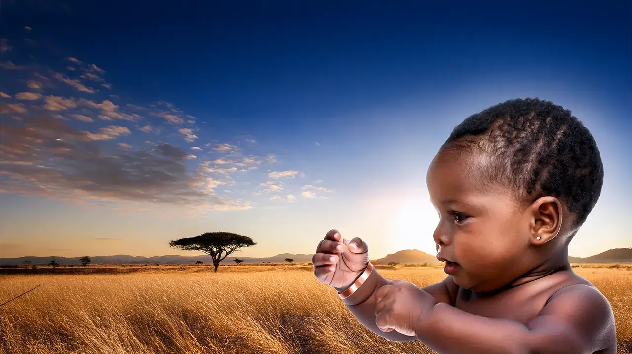Baby with African savannah landscape at sunset.